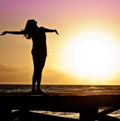 joyous woman at sunset